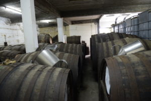 Rows of wooden rum casks in the Abel Fernandes ageing cellar in Madeira